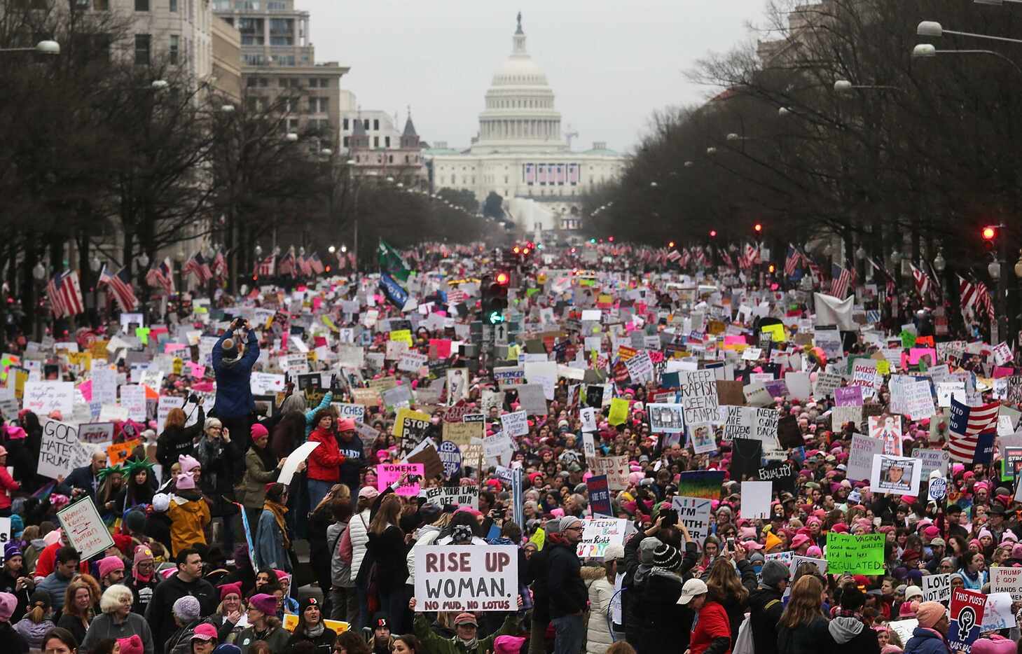Protesters walk during the Women's March on Washington, with the U.S. Capitol in the...
