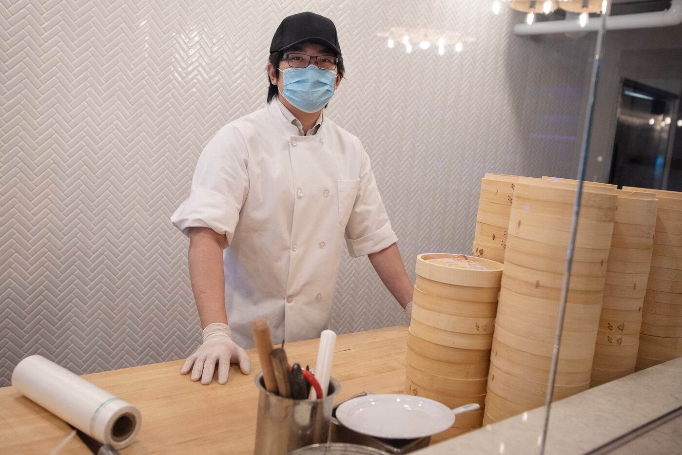 Ian Peng, 22, owner of Kitchen Master, behind the dumpling window inside his restaurant in...