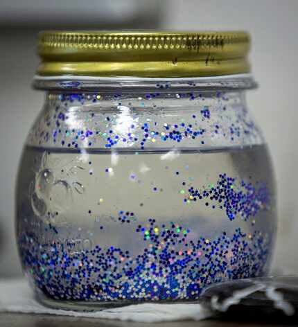 A "glitter jar" sits on a table with other tools for mindfulness at Davis Elementary Monday,...