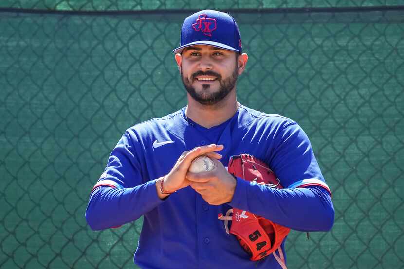 Texas Rangers pitcher Martin Perez works in the bullpen during a spring training workout at...