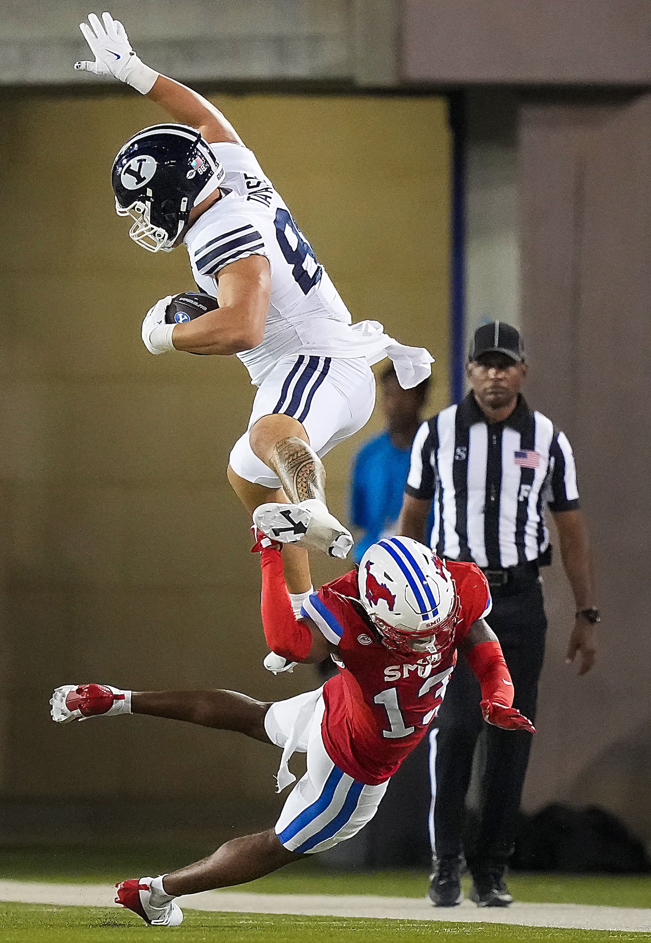 BYU tight end Mata'ava Ta'ase (88) tries to hurdle SMU cornerback Jaelyn Davis-Robinson (13)...