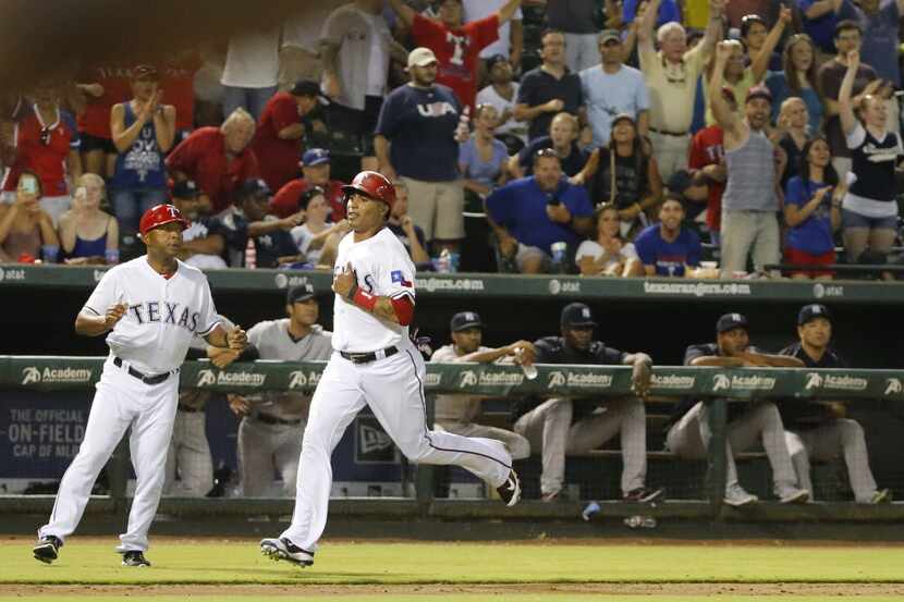 Texas Rangers center fielder Leonys Martin (2) comes home with the winning run in the bottom...