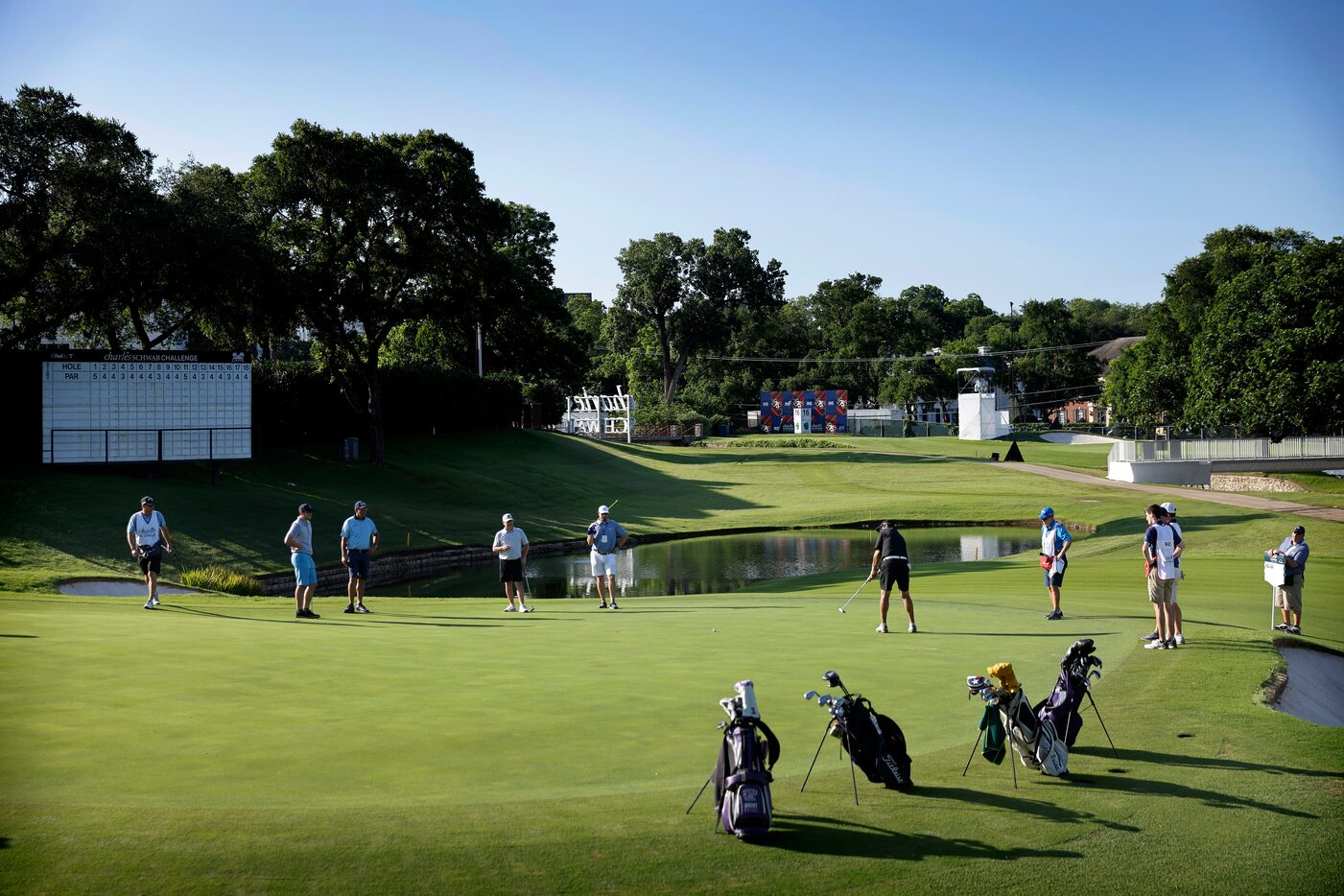 Golfer Phil Mickelson and his four some play the par-3 No. 17 in the Charles Schwab...