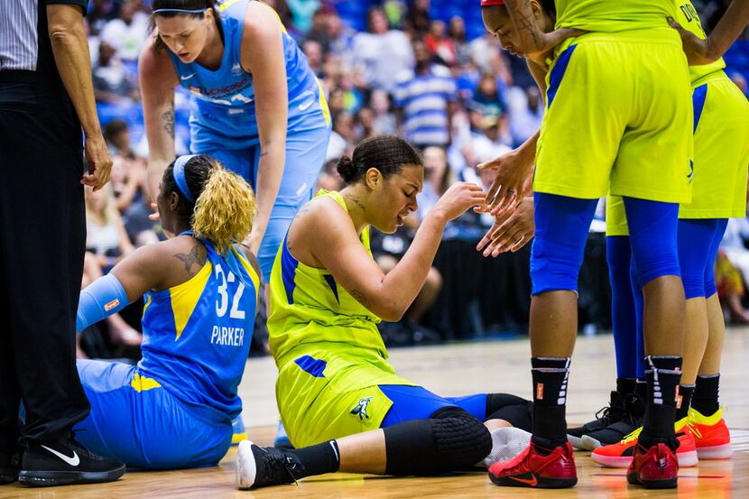 Dallas Wings center Liz Cambage (8) reacts to colliding with Chicago Sky forward Cheyenne...