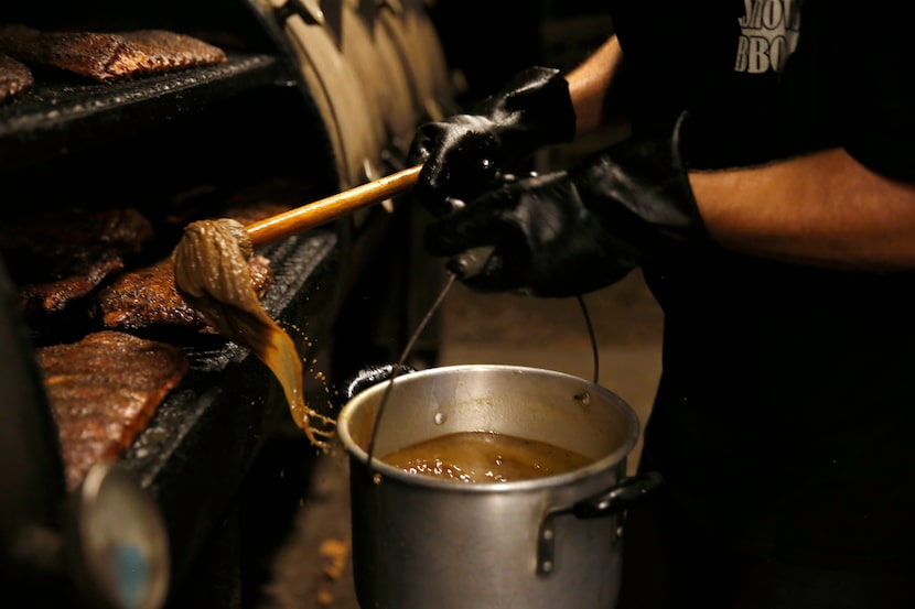 Clay Cowgill mops the ribs.