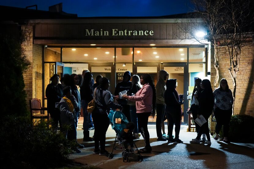 People gathered outside after a prayer service for Arlington Lamar High School at New World...