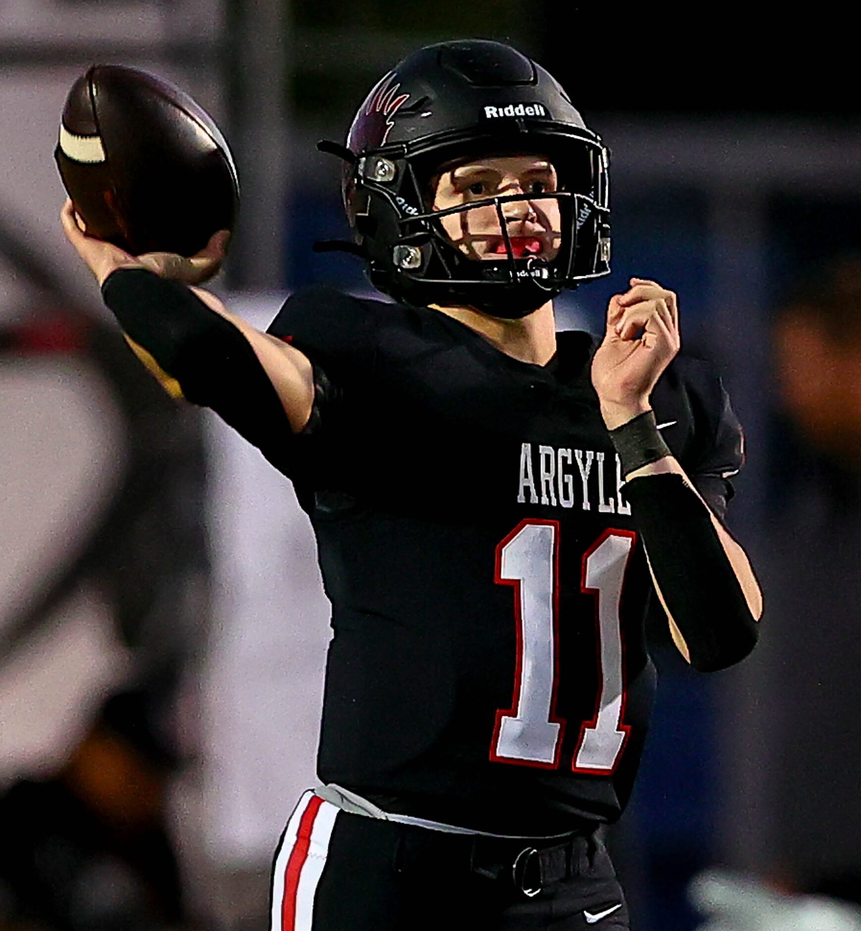 Argyle quarterback Maguire Gasperson attempts a pass against Frisco Emerson during the first...