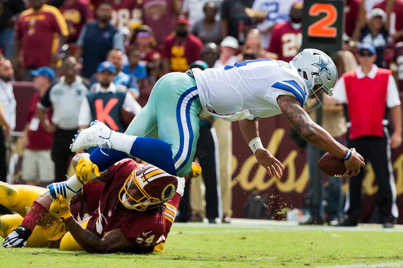 Dallas Cowboys quarterback Dak Prescott (4) dives for a touchdown past Washington Redskins...