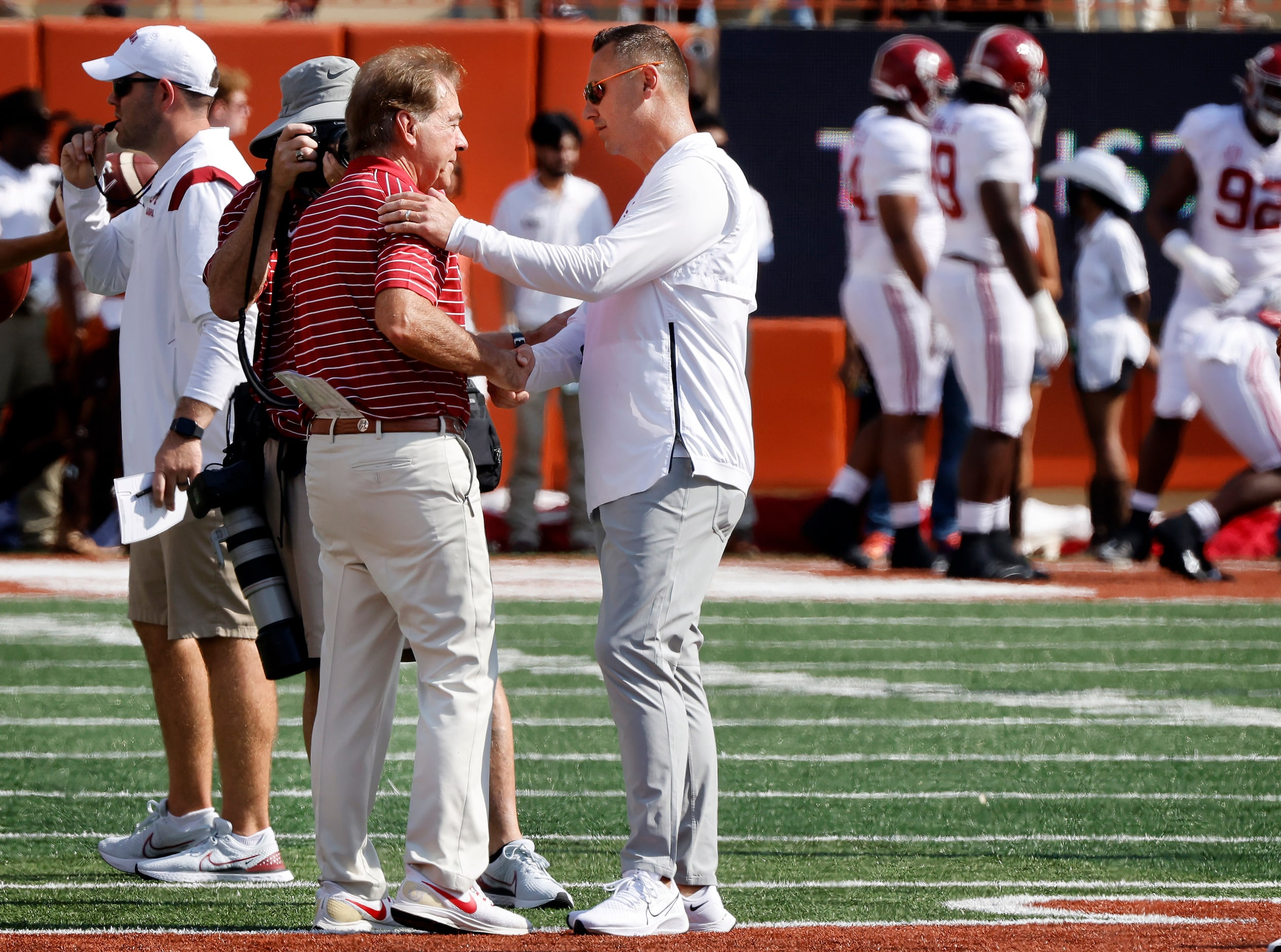 Texas Longhorns head football coach Steve Sarkisian (right) and Alabama Crimson Tide head...