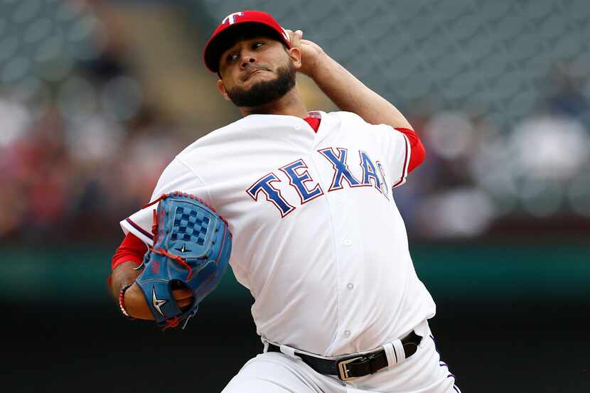 Texas Rangers starting pitcher Martin Perez delivers to a Seattle Mariners batter during the...