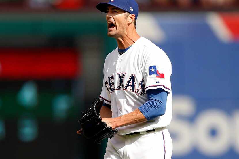 Texas Rangers starting pitcher Cole Hamels (35) reacts after giving up a single to Houston...