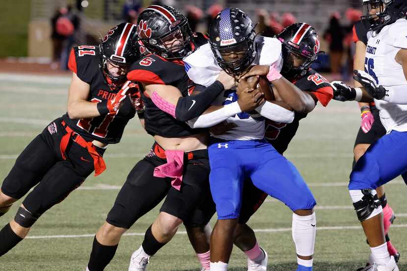 Mansfield Summit running back Orlando Scales (23) is tackled by Colleyville Heritage...