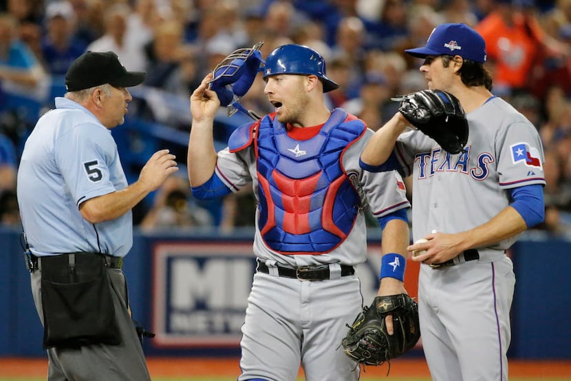 Texas Rangers catcher Chris Gimenez (38) has words with home plate umpire Dale Scott during...