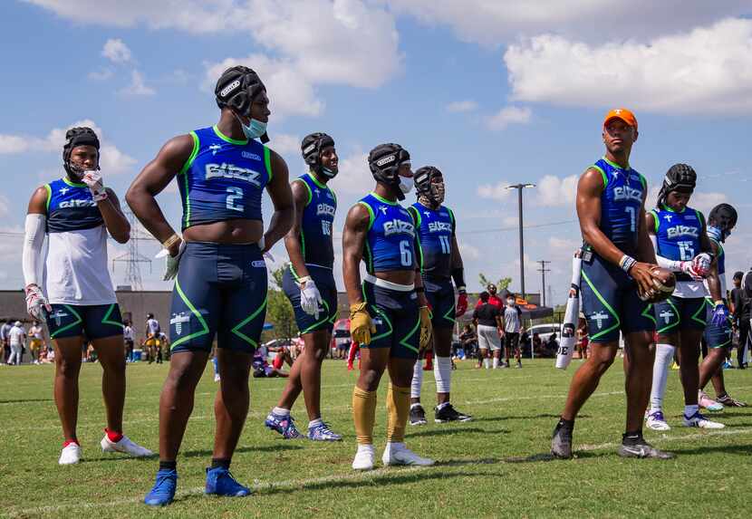 The offense team for Buzz Gang waits to play against Team Grind Red during the Pylon 7-on-7...