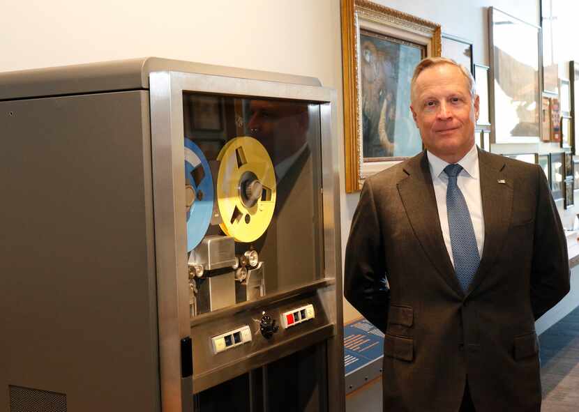 Ross Perot Jr., chairman of the Perot Group and Hillwood, stands next to the IBM 729...