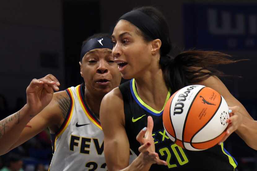 Dallas Wings forward Isabelle Harrison (20) drives to the basket as she is defended by...