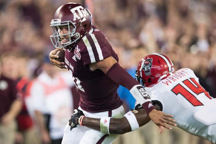 Texas A&M quarterback Kellen Mond (11) is tackled by North Carolina State safety Dexter...