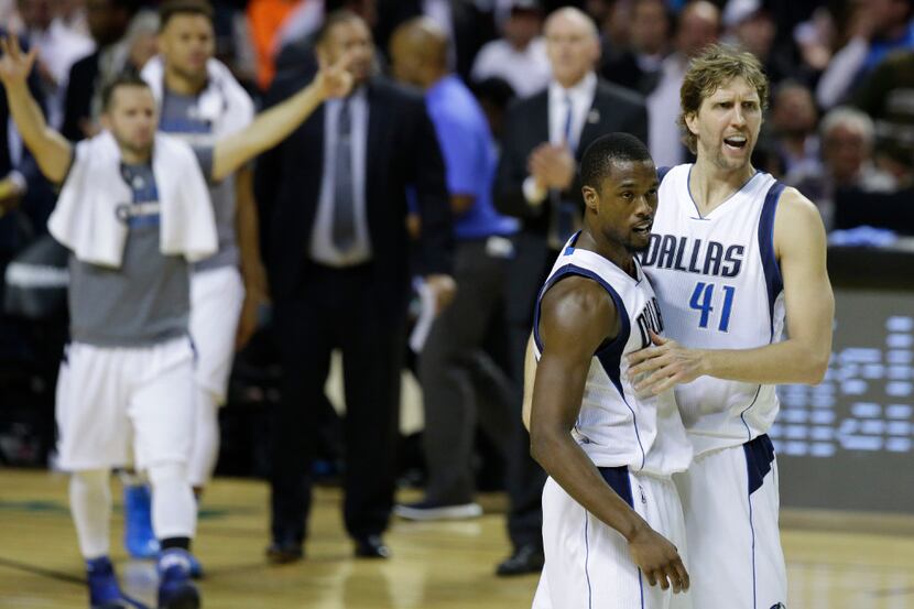 Dirk Nowitzki, right, celebrates with Harrison Barnes as time runs out at the end of their...