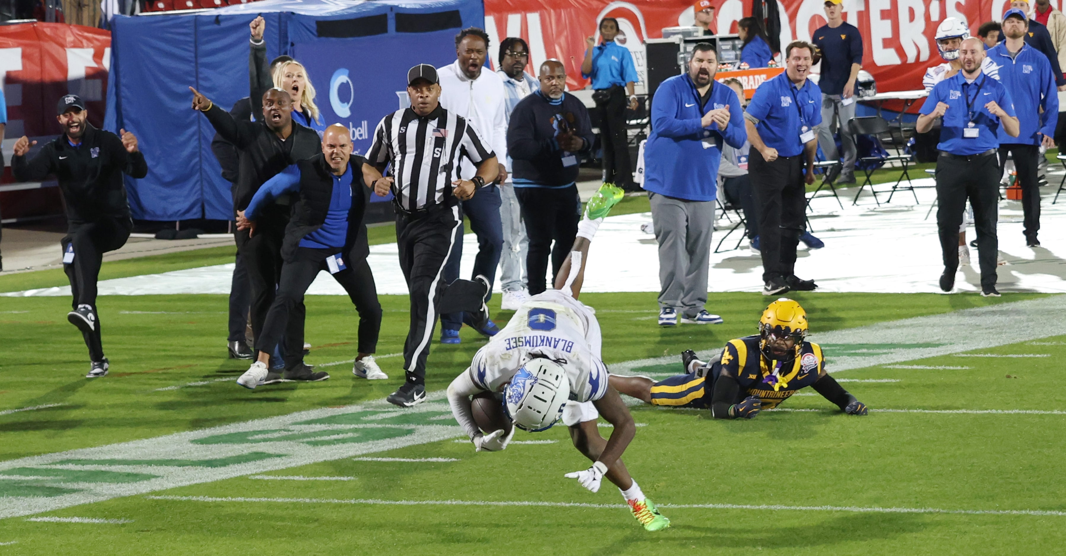 The Memphis Tigers bench area erupted as Memphis receiver Demeer Blankumsee (0) is tripped...