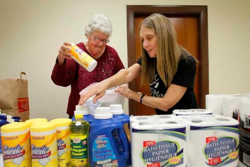 
Volunteers Maunette Lively and Peggy Marquez put together care bags for clients.
