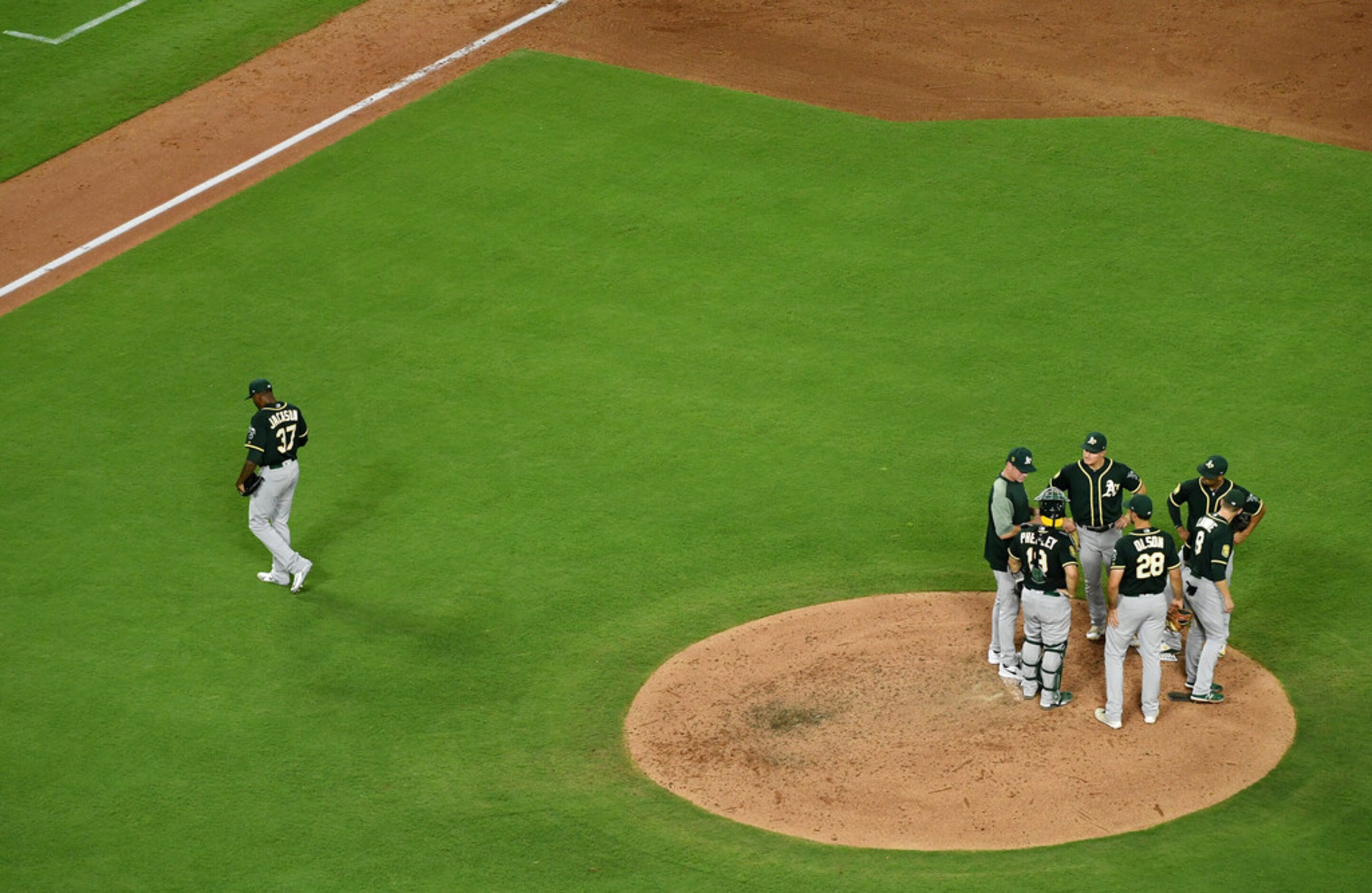 Oakland Athletics starting pitcher Edwin Jackson walks to the dugout after being pulled from...