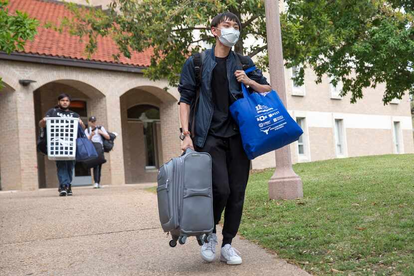 Chris Hsu, 19, a freshman at the University of Texas, moves out of Jester dormitory for a...