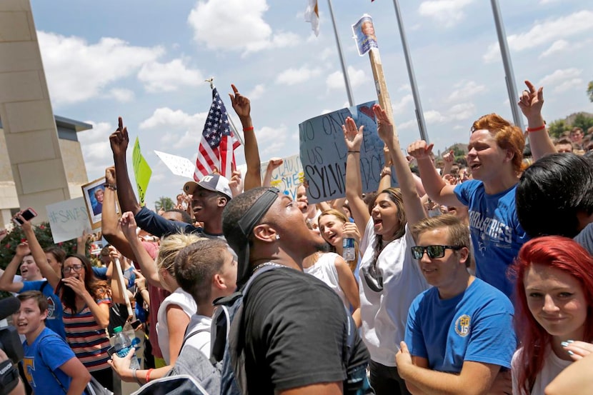 
Frisco High senior Darrell Woolen (center) rallied others Tuesday at the Frisco ISD...