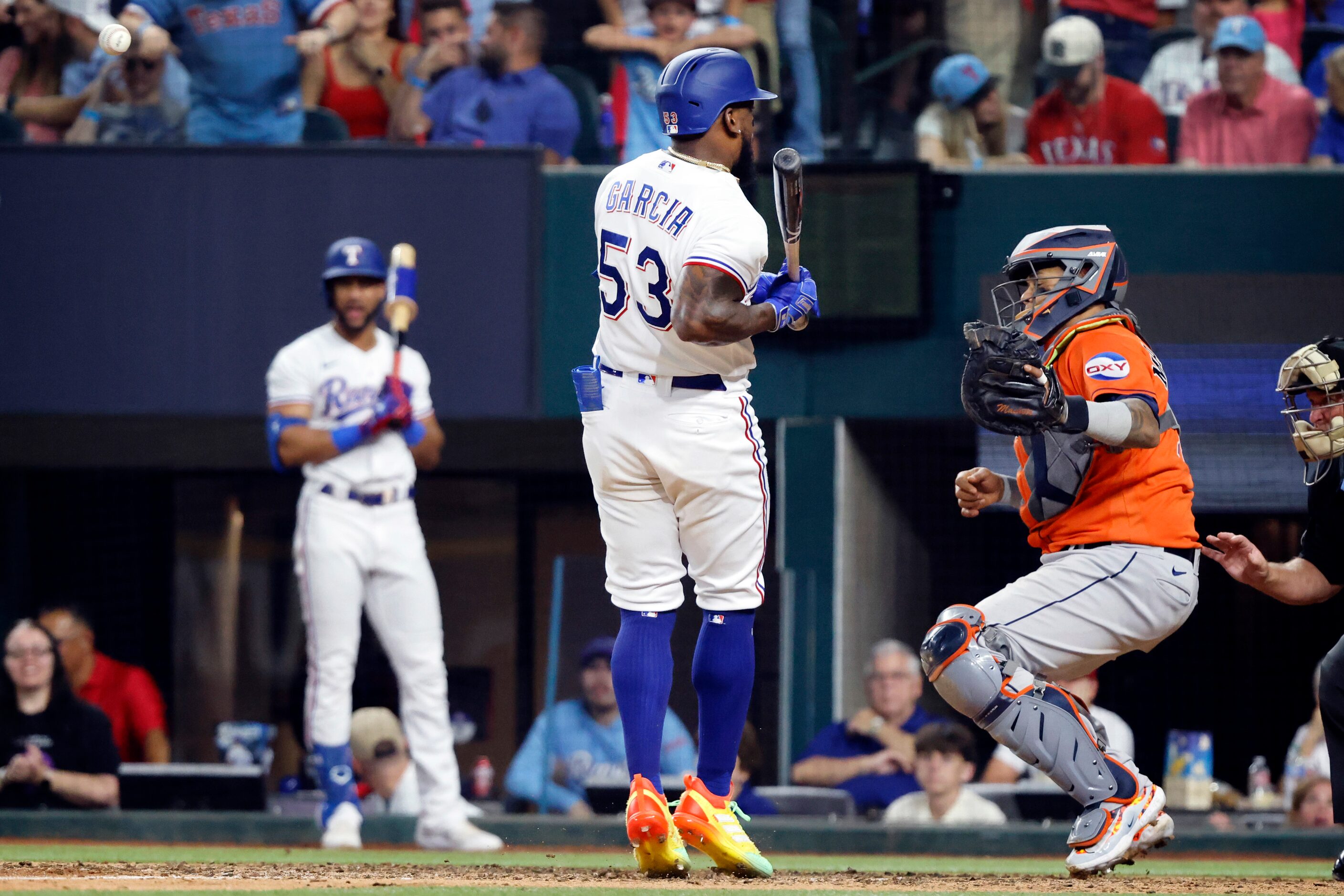 Texas Rangers batter Adolis Garcia (53) is hit with a pitch by Houston Astros relief pitcher...