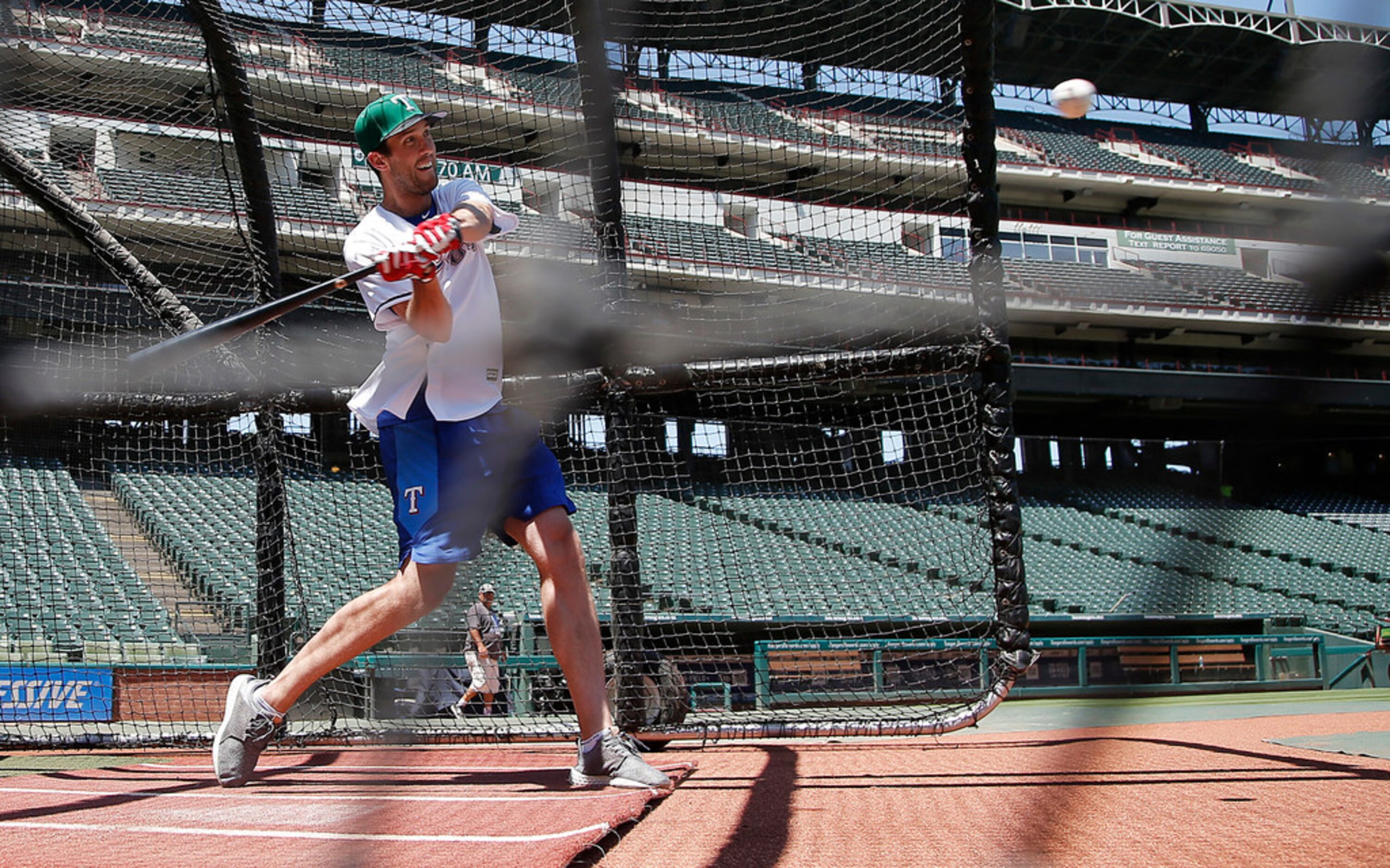 Dallas Stars goalie Ben Bishop swings at a pitch during a batting practice with the Texas...