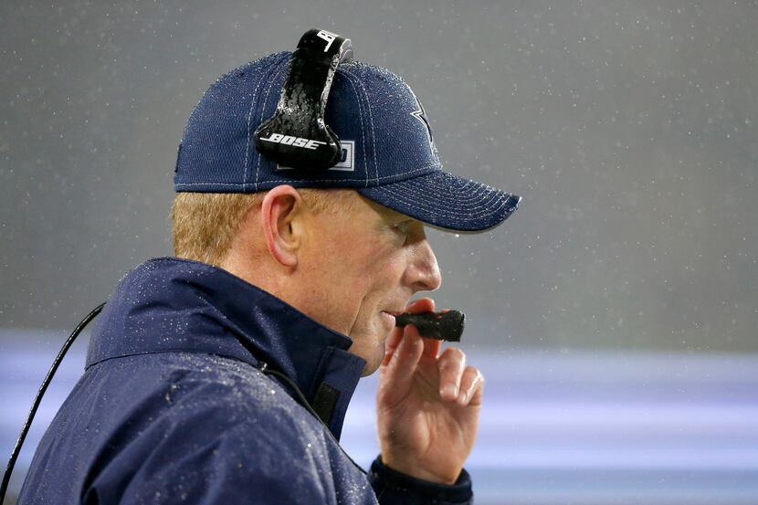 Dallas Cowboys head coach Jason Garrett was not immune to the driving wind and rain as he...