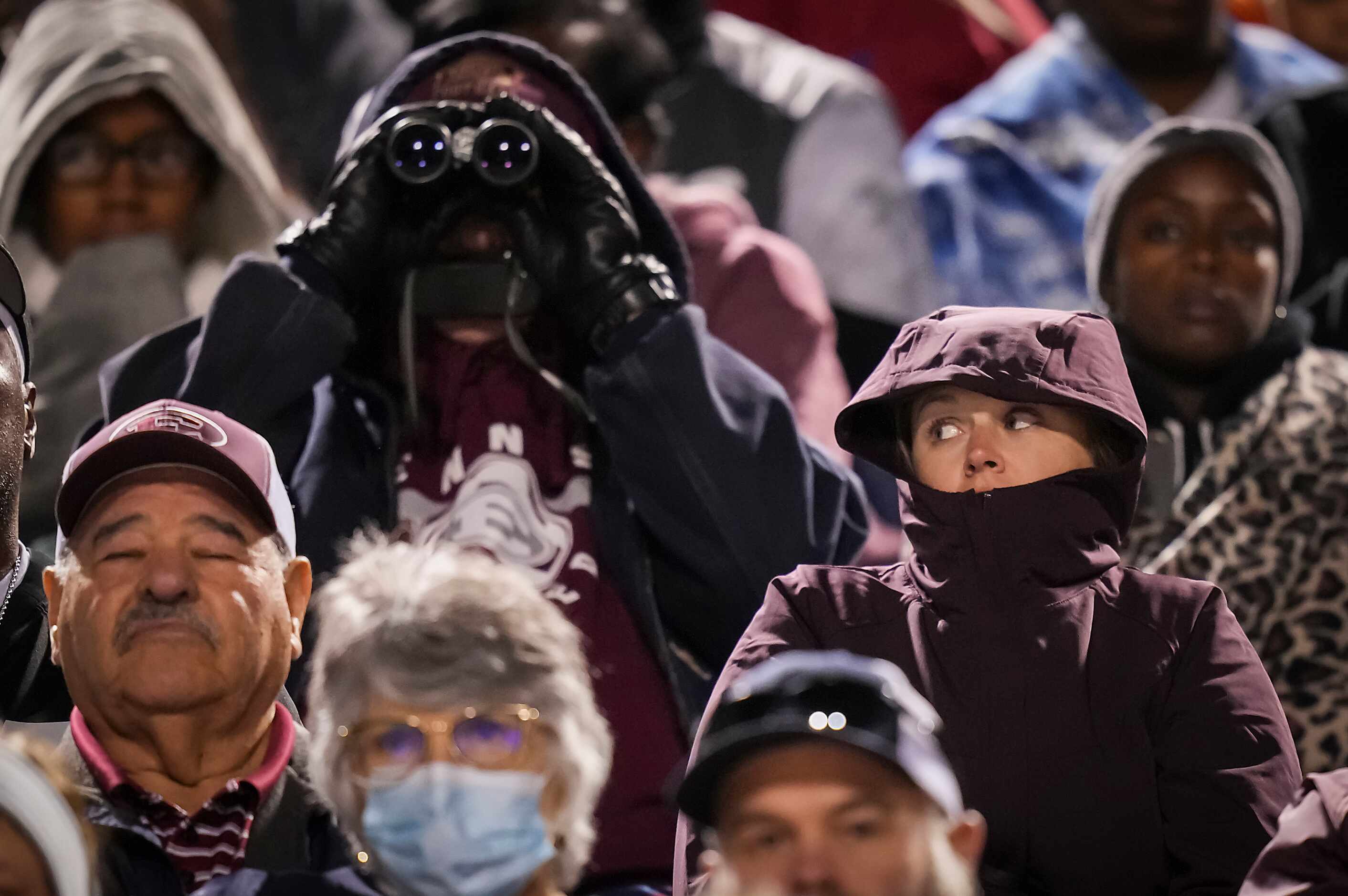 Ennis fans bundle up against a chilly evening during the second quarter of a District 8-5A...