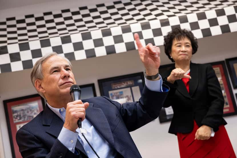 Rep. Angie Chen Button gave a thumbs down as Gov. Greg Abbott spoke about Democratic rival...