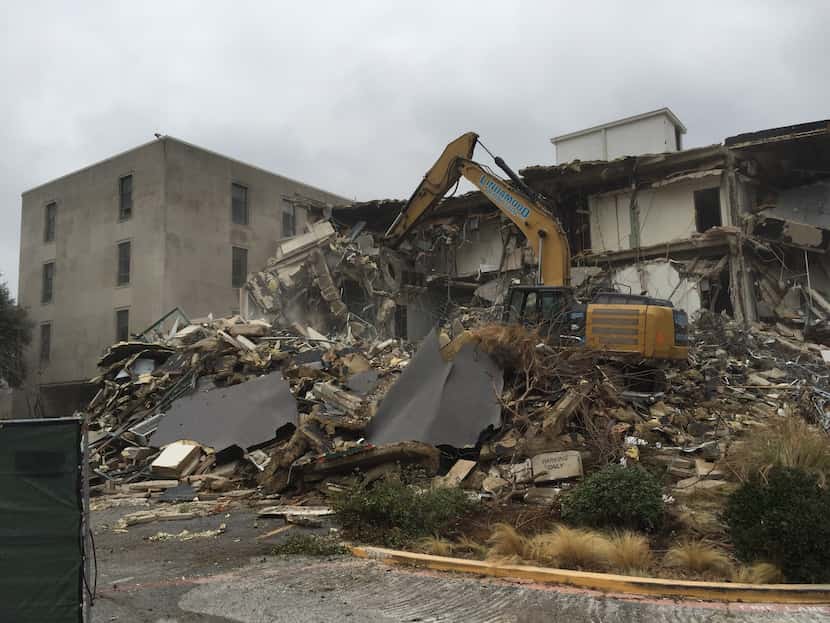 Crews work on tearing down most of the former Dallas ISD headquarters on Ross Avenue,...
