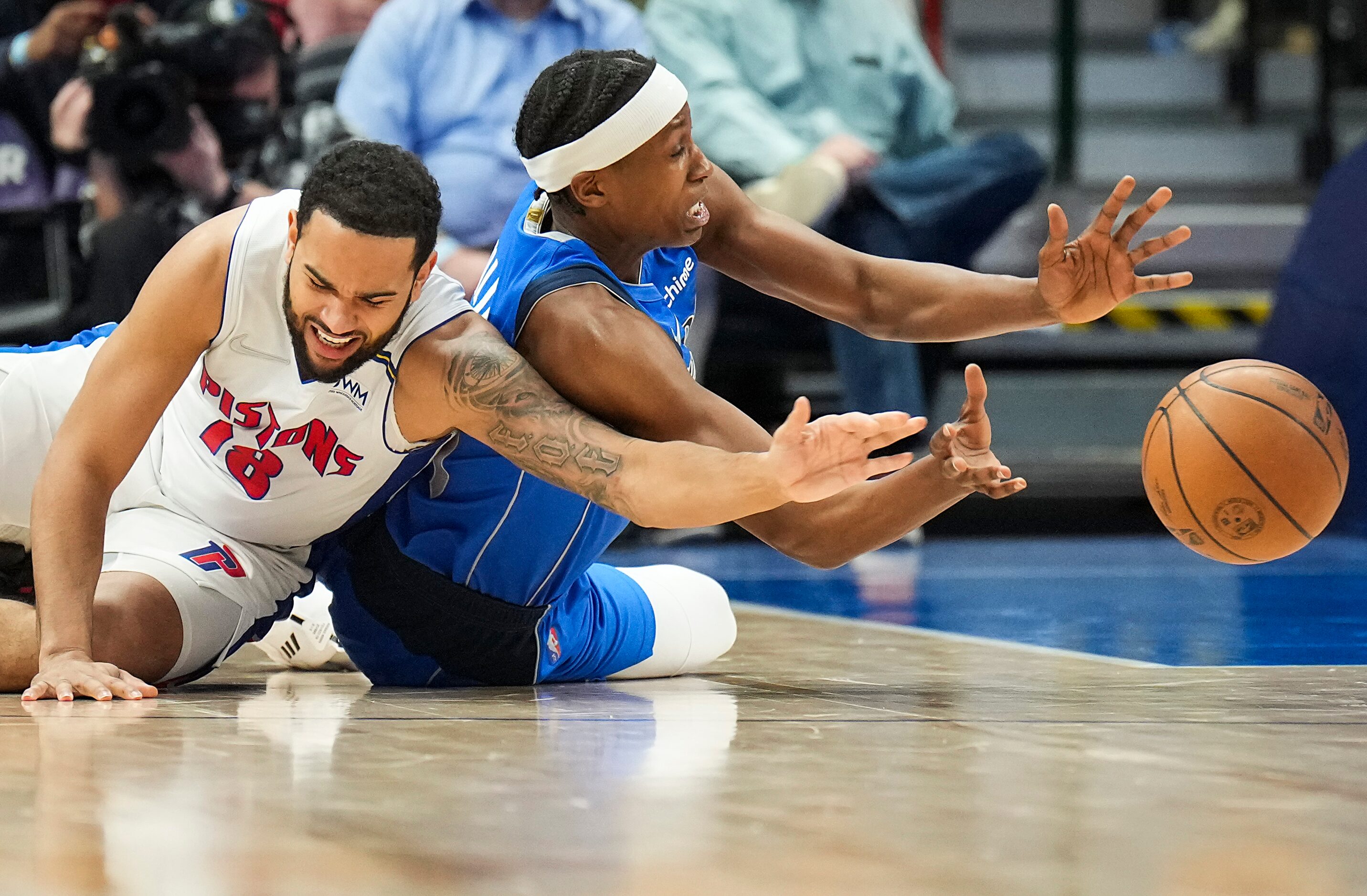 Dallas Mavericks guard Frank Ntilikina (21) fights for a loose ball against Detroit Pistons...