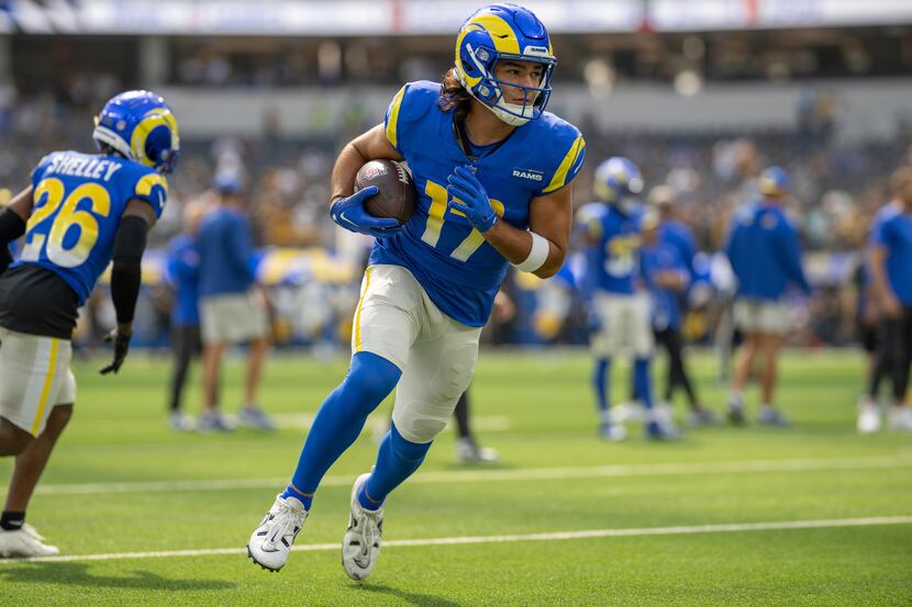 Los Angeles Rams wide receiver Puka Nacua (17) runs with the ball before an NFL football...