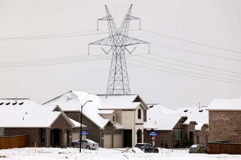 Large electrical transmission lines are pictured in a housing development in South...