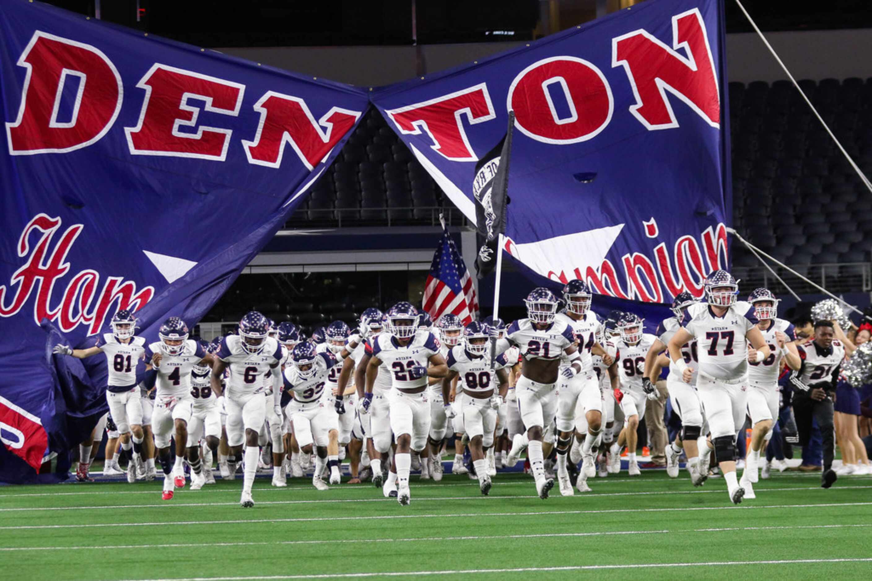 Denton Ryan runs out before a Class 5A Division I state championship game against Alvin...