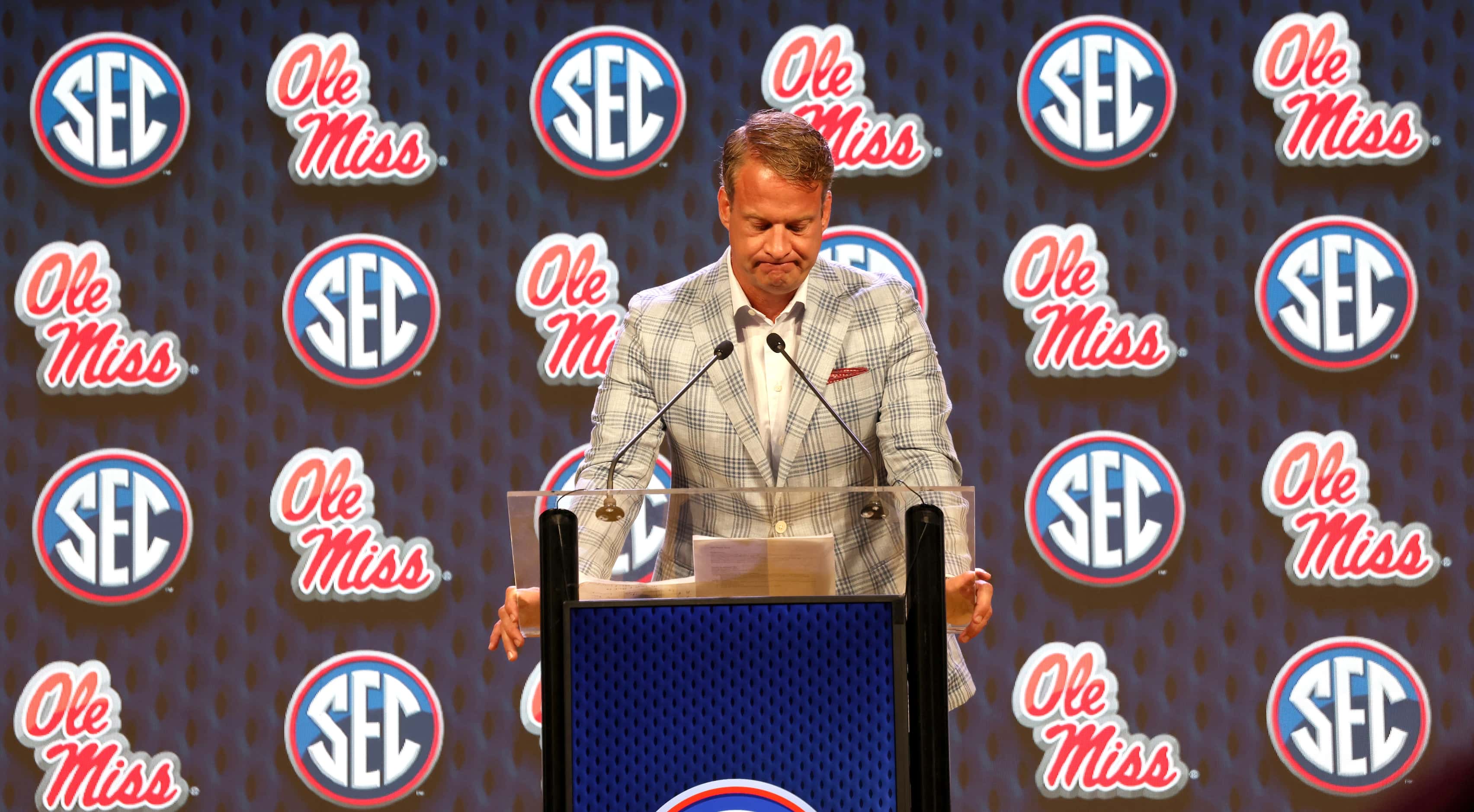 Lane Kiffin, head coach of the Ole Miss Football team, pauses at the podium after sharing...
