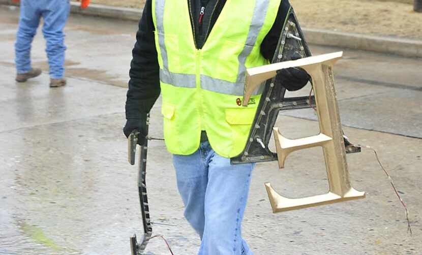 A worker removes the Sigma Alpha Epsilon letters from the fraternity's house on the...