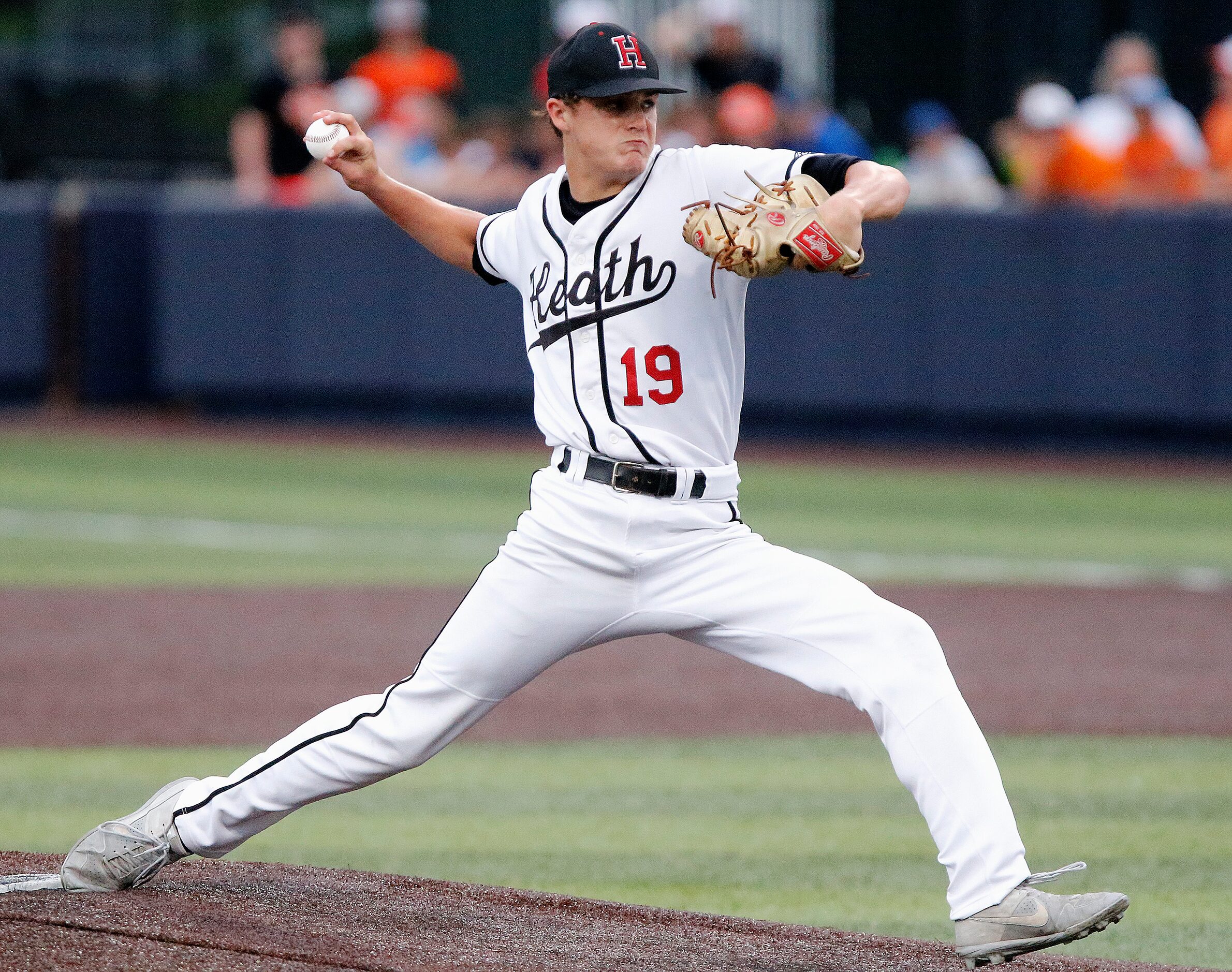 Heath pitcher Jonny Lowe (19) delivers a pitch in the first inning as Rockwall Heath High...