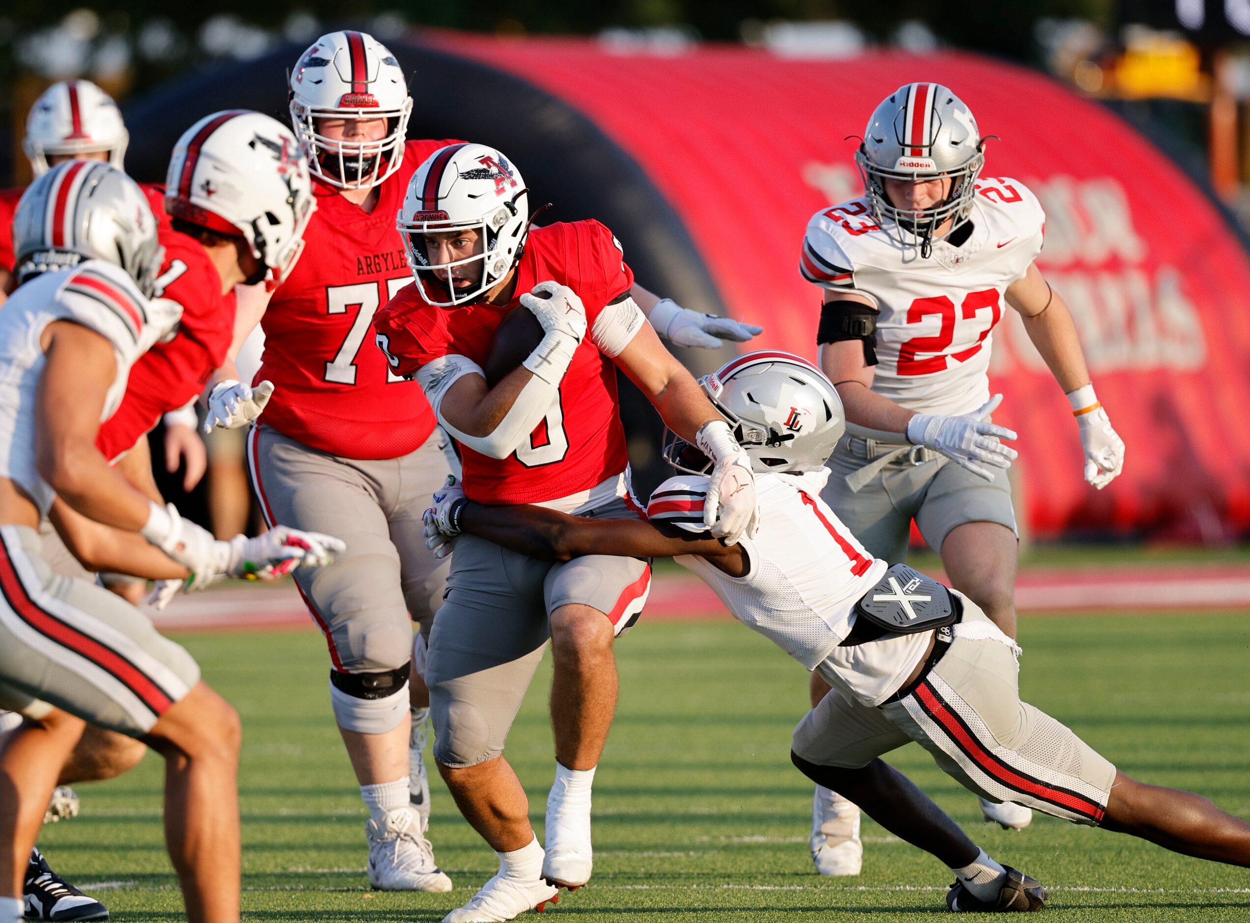 Argyle's Devon Owen (0) is tackled by Lovejoy's Jalen Lott (1) during the first half of a...