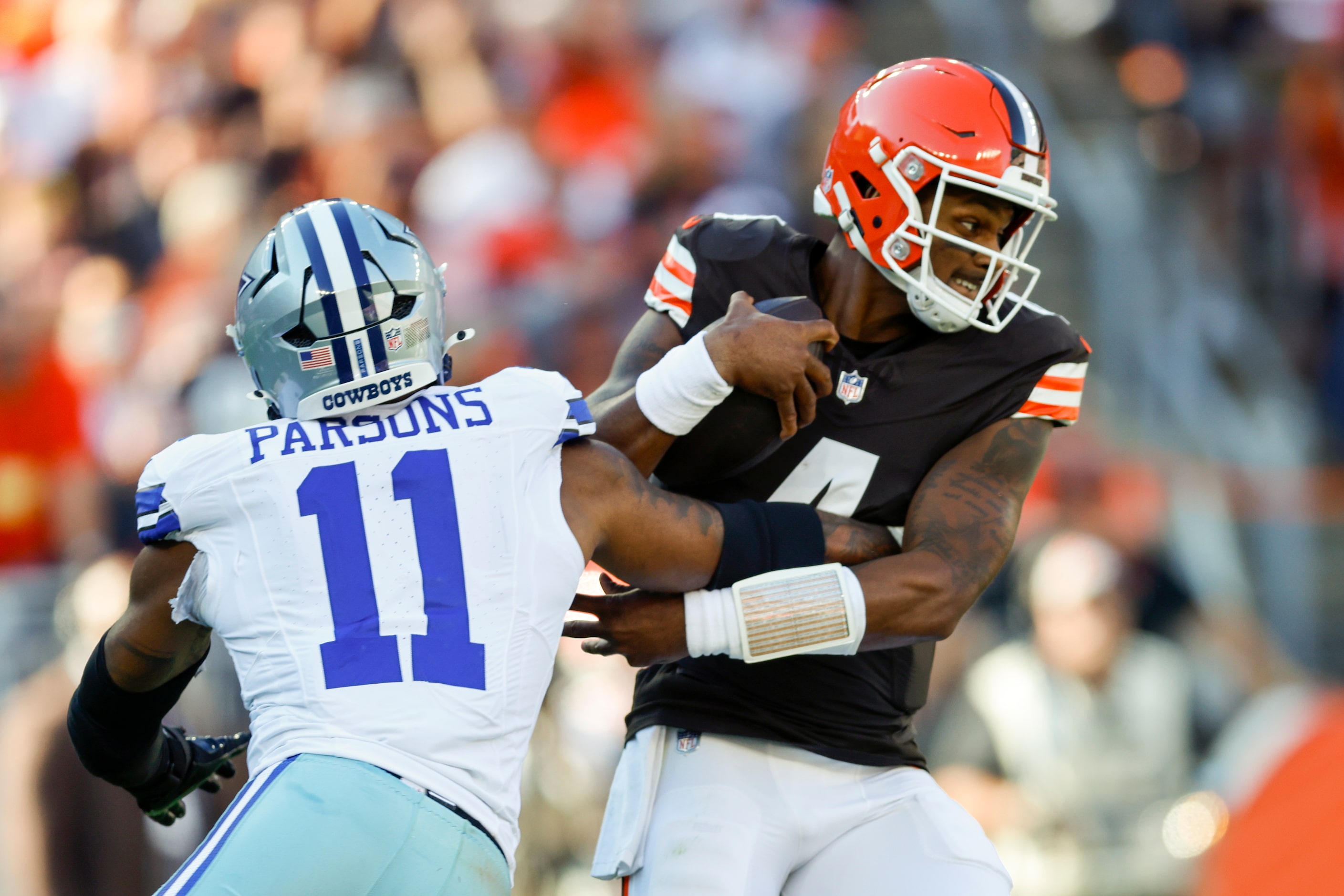 Dallas Cowboys linebacker Micah Parsons (11) slips off Cleveland Browns quarterback Deshaun...