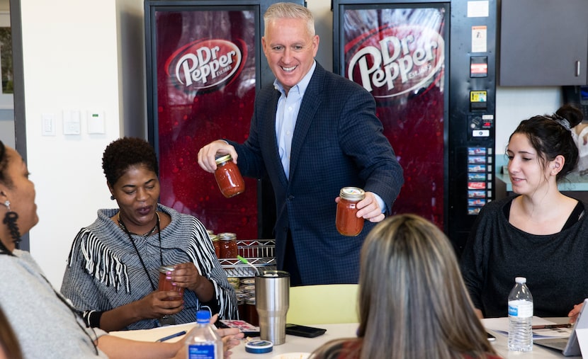 President and CEO Lynn Davis passes out jars of his homemade salsa at Dallas Children's...