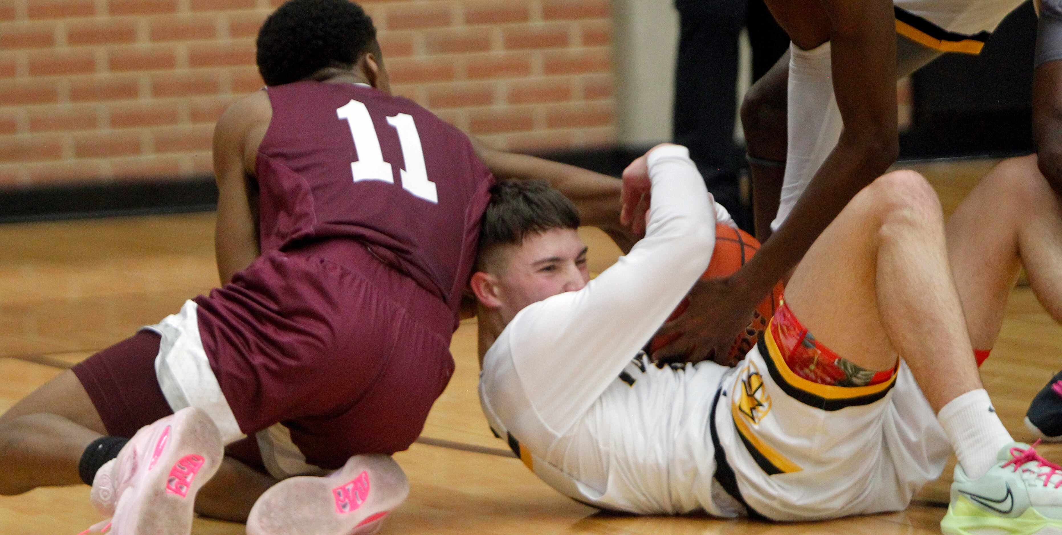 Forney's Jordan Fabian (13), right, fights to keep possession as Red Oak's Michael Gatewood...