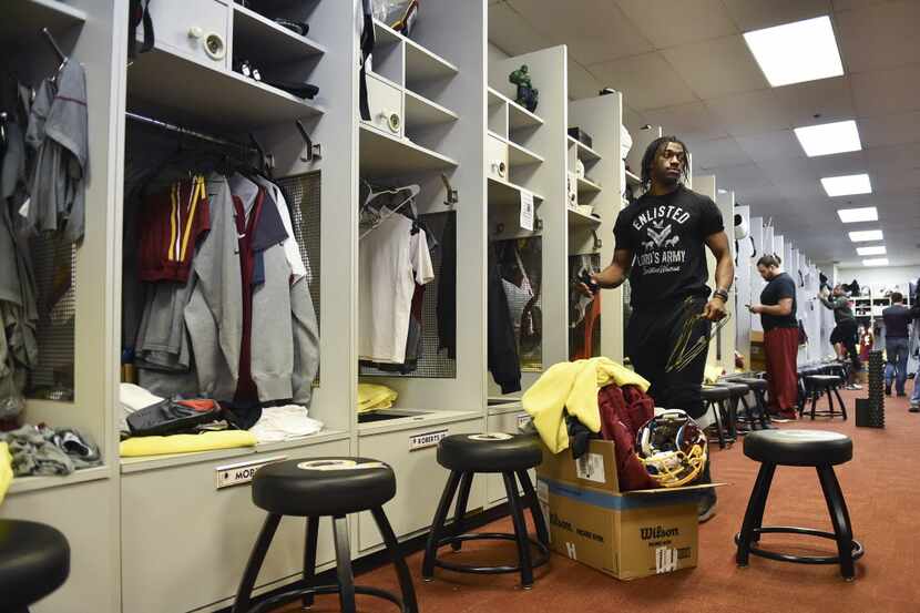 Washington Redskins quarterback Robert Griffin III clears his locker at Redskins Park,...