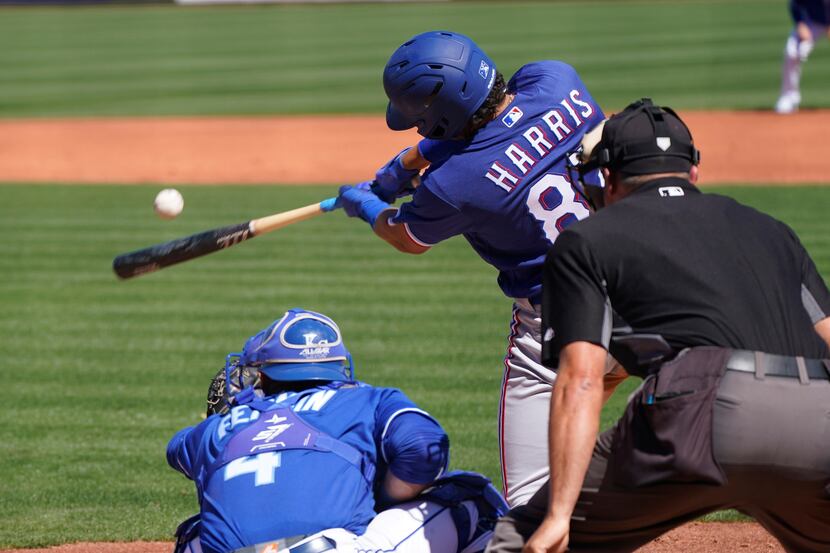 Baseball’s back and Texas Rangers’ Dustin Harris gets a hit during their game against the...