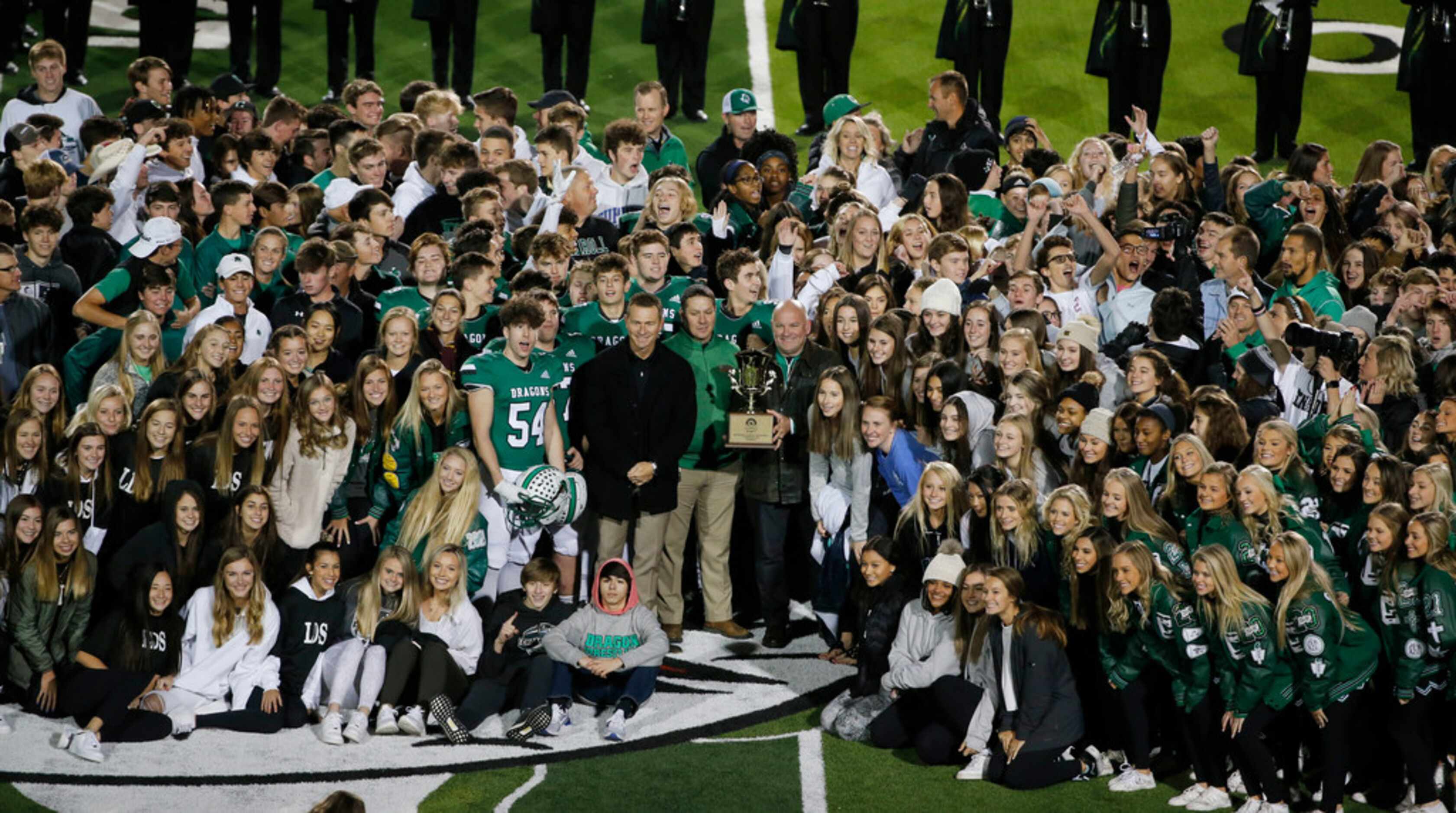 Southlake Carroll celebrates the presentation of the Lone Star Cup at halftime of their high...