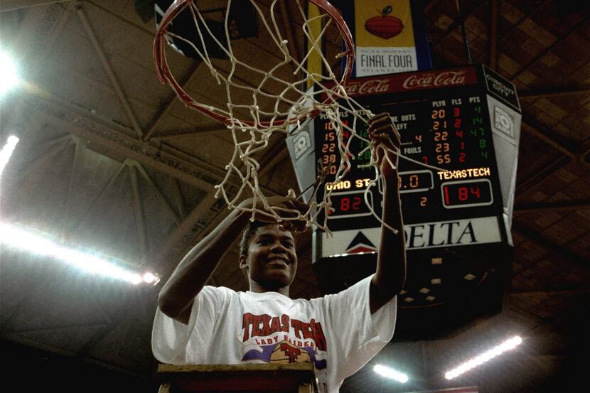 Sheryl Swoopes of Texas Tech cuts down the net after leading her team to victory over Ohio...