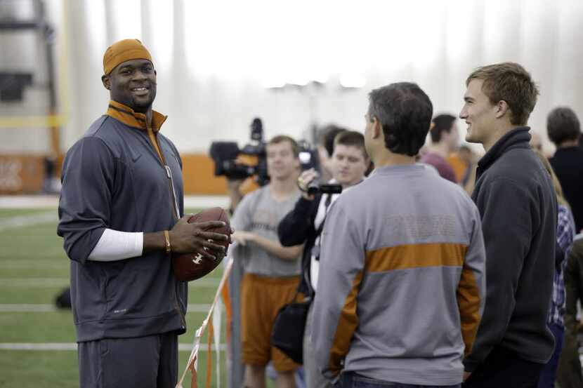 Former University of Texas and NFL quarterback Vince Young, left, talks with Texas...