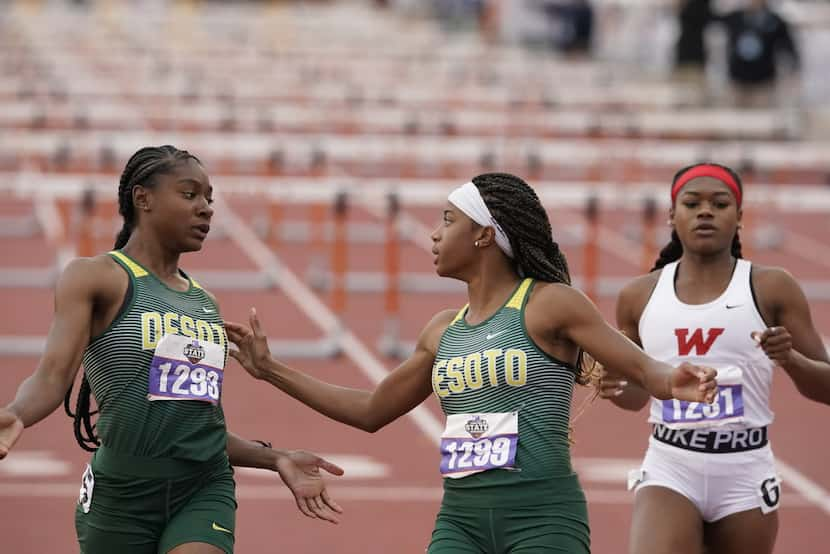 Desoto's Jayla Hollis (1293) greets teammate Jalysi'ya Smith (1299) at the finish of the...